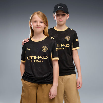 Manchester City Away Jersey Youth in black with gold PUMA and club details.