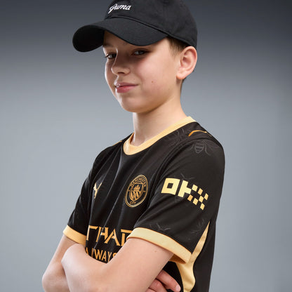 Manchester City Away Jersey Youth in black with gold PUMA and club details.