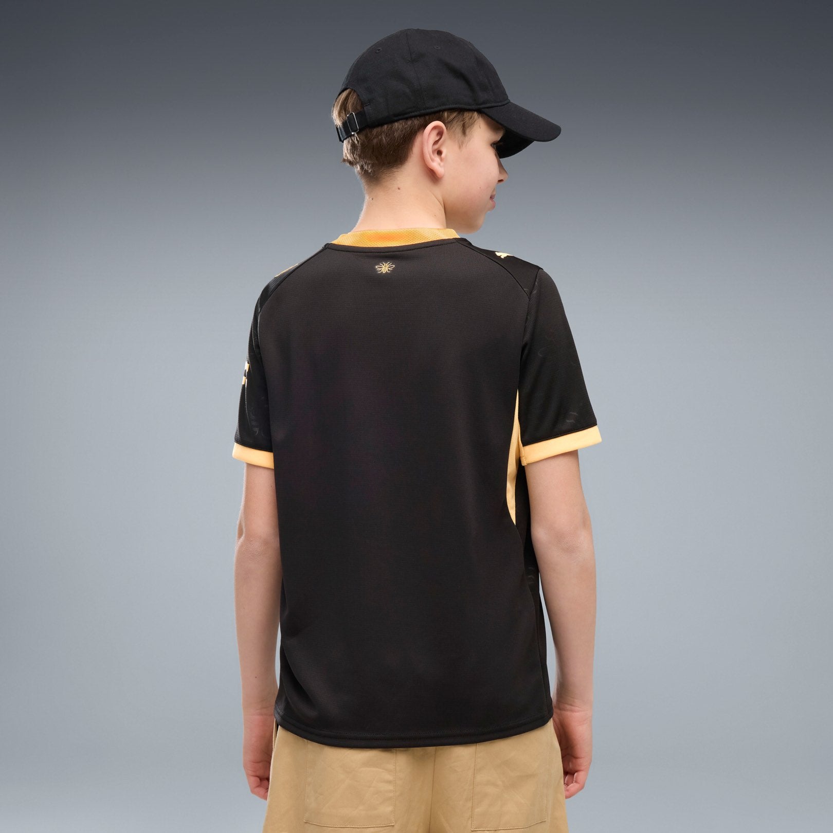 Manchester City Away Jersey Youth in black with gold PUMA and club details.